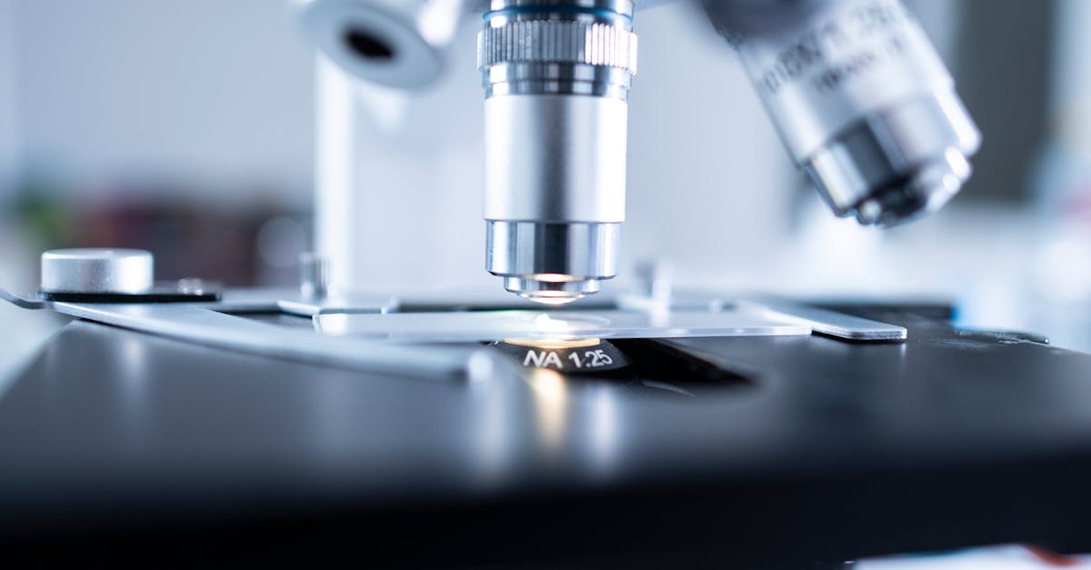 Detailed view of a laboratory microscope focusing on lens and optical components.
